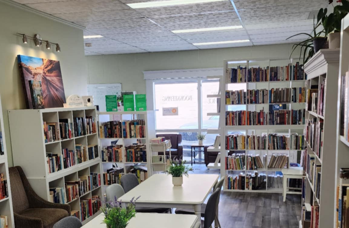 Blended Book Nook interior with tables, chairs, and bookshelves.

